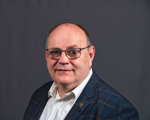 Male corporate headshot shot on a grey background