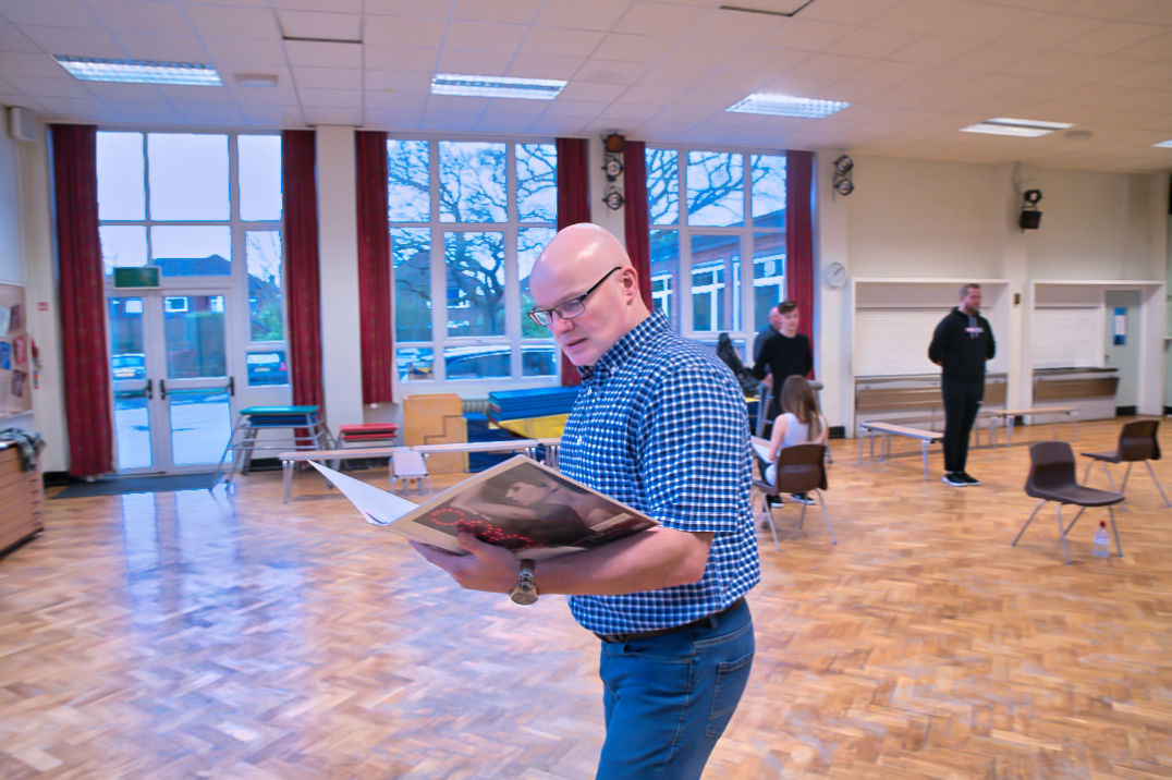 female and male dancers and actors at a rehearsal for Chicago 