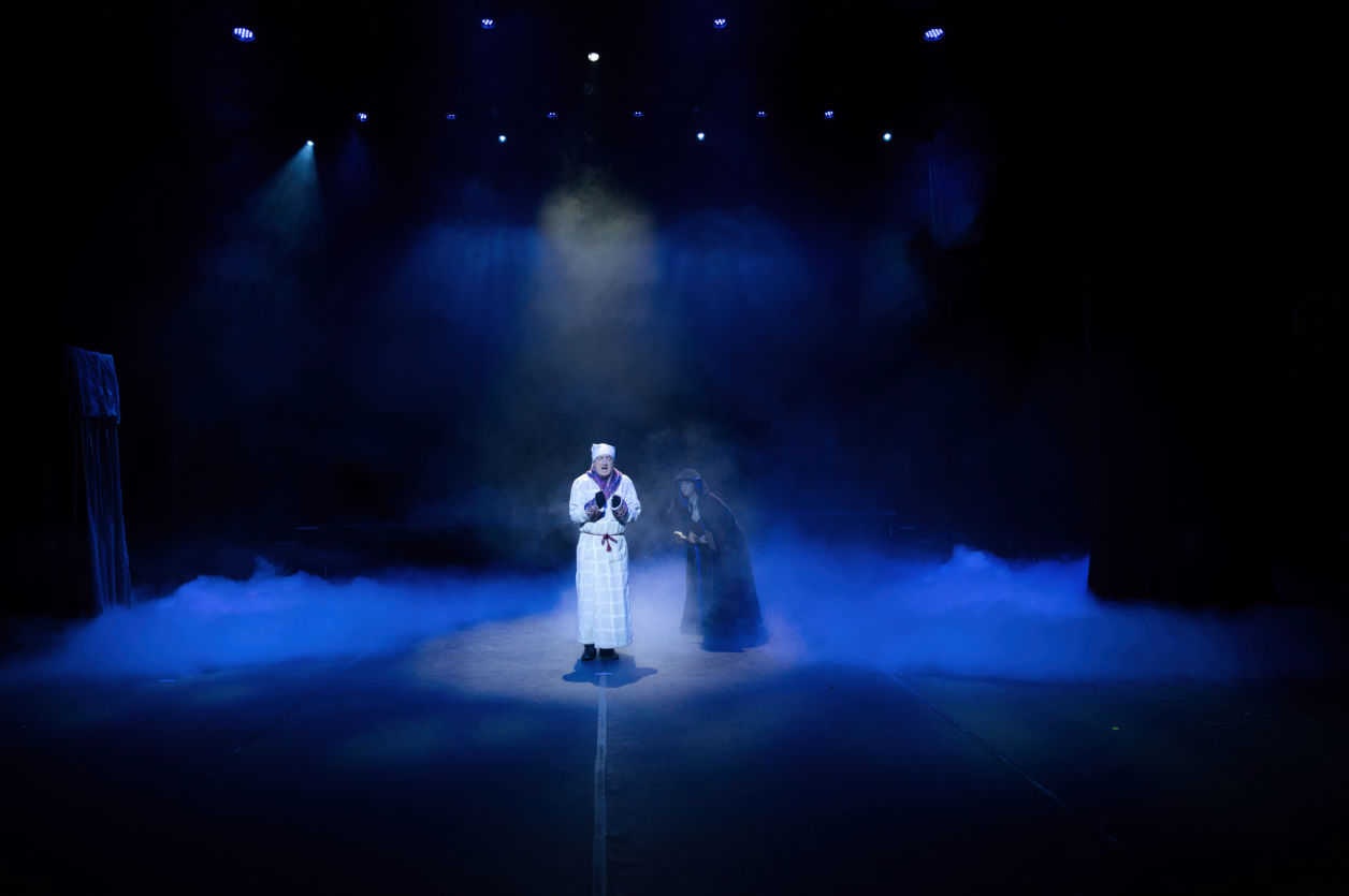Actor on the main stage with a ghost of Christmas past form the musical Christmas Carrol